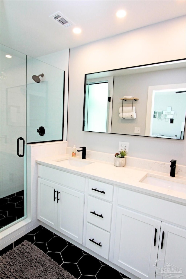 157 S Spring St, Pensacola, FL 32502 - bathroom with double vanity, a shower stall, tile patterned floors, and recessed lighting