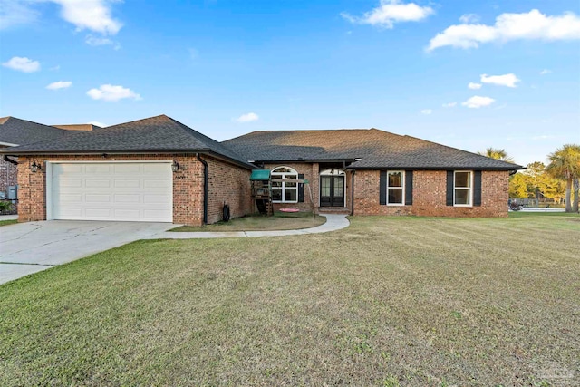 view of front of property with a garage and a front lawn