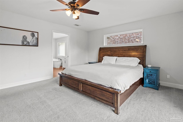 carpeted bedroom with connected bathroom and ceiling fan