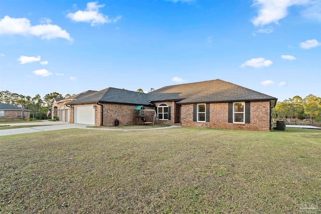 ranch-style home with a garage, a front lawn, and central air condition unit