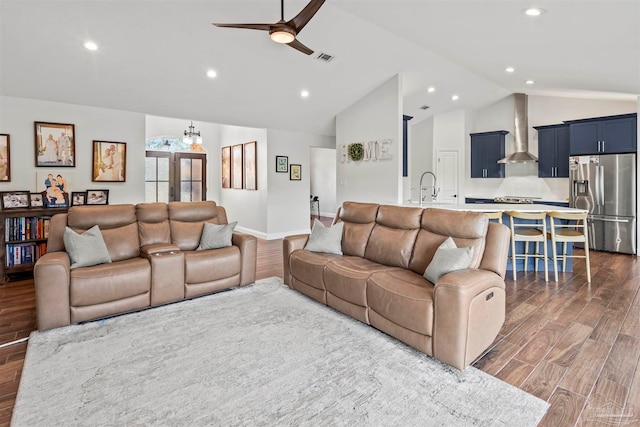 living room featuring ceiling fan, sink, and lofted ceiling