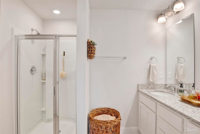 bathroom with vanity and a shower with shower door