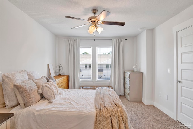 bedroom with light carpet, a textured ceiling, and ceiling fan