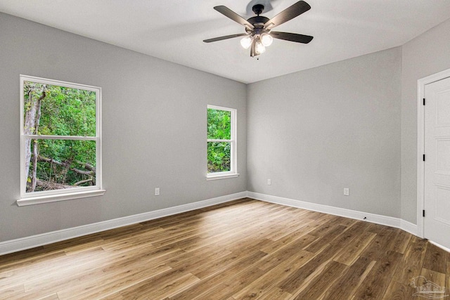 spare room with ceiling fan and wood-type flooring