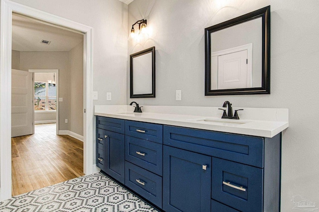 bathroom featuring double vanity and hardwood / wood-style floors