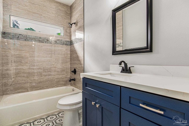 full bathroom with tiled shower / bath combo, vanity, and toilet