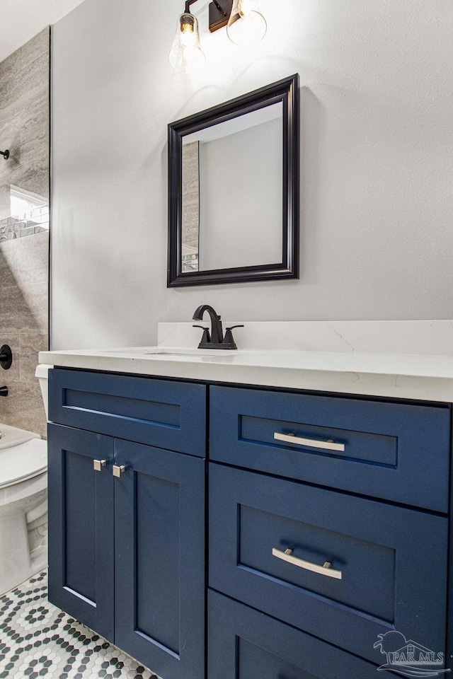 bathroom with tile patterned floors, vanity, and toilet