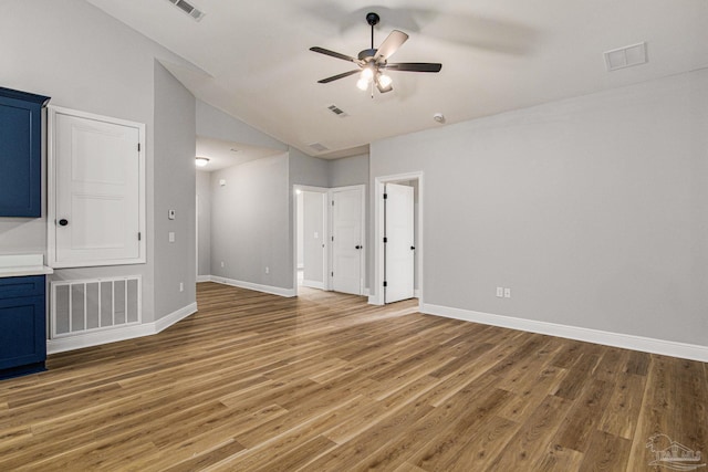 unfurnished living room featuring hardwood / wood-style flooring, high vaulted ceiling, and ceiling fan