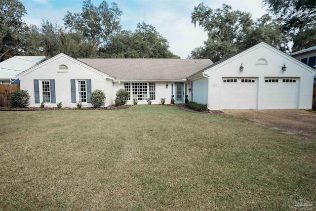 single story home with a garage and a front lawn