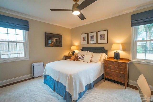 bedroom featuring ceiling fan, ornamental molding, and light hardwood / wood-style flooring