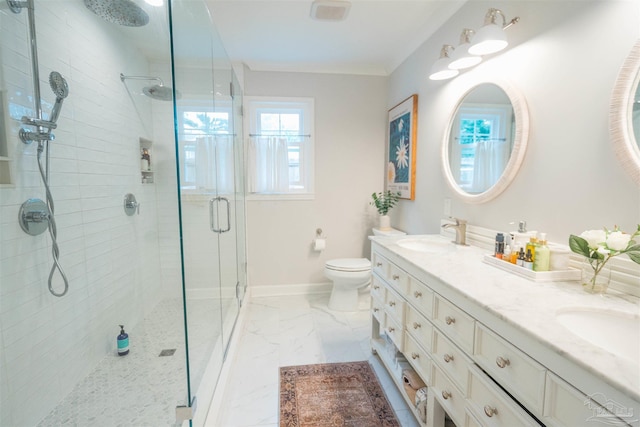 bathroom featuring vanity, toilet, a shower with door, and ornamental molding