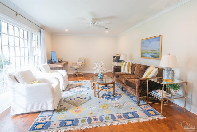 living room featuring hardwood / wood-style flooring, ceiling fan, and ornamental molding