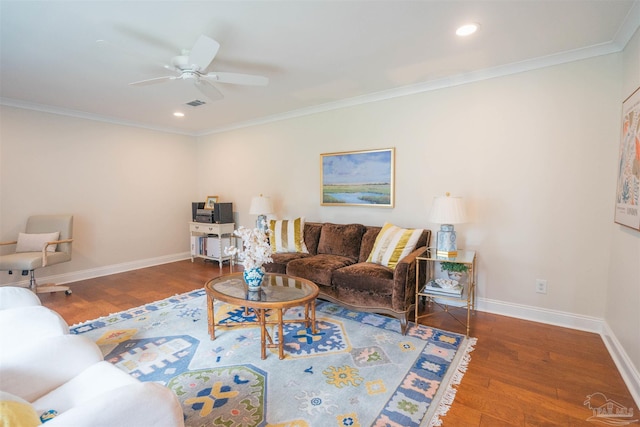 living room with dark hardwood / wood-style floors, ceiling fan, and crown molding