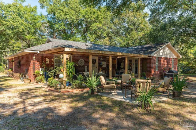 rear view of property with french doors and a patio