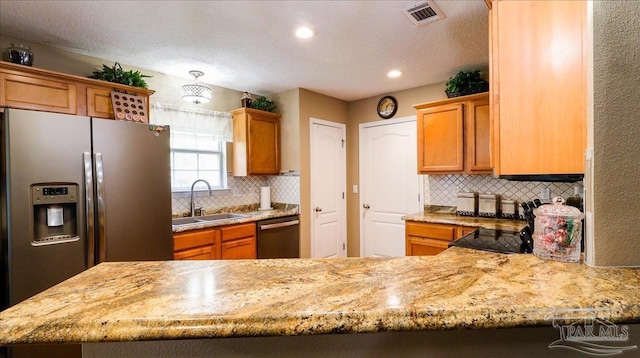 1462 Camrose Pl, Pensacola, FL 32534 - kitchen featuring appliances with stainless steel finishes, a sink, tasteful backsplash, a peninsula, and recessed lighting