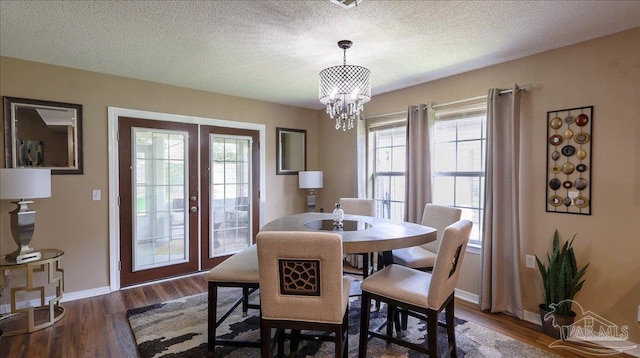 1462 Camrose Pl, Pensacola, FL 32534 - dining area with french doors, baseboards, dark wood-style floors, a chandelier, and a textured ceiling