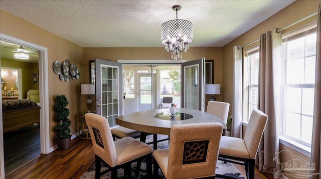 1462 Camrose Pl, Pensacola, FL 32534 - dining area with dark wood-style flooring, french doors, a chandelier, baseboards, and a textured ceiling
