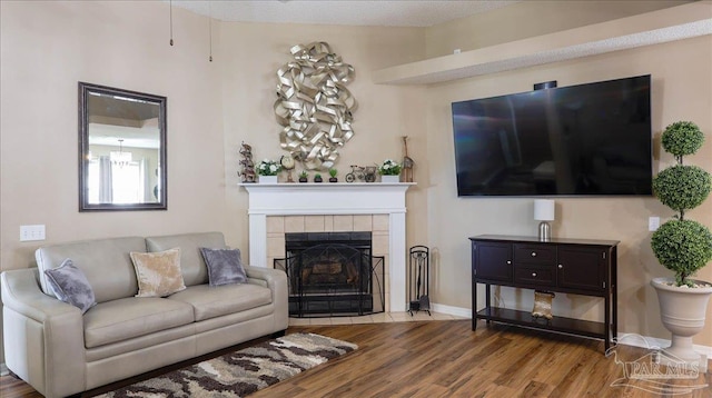 1462 Camrose Pl, Pensacola, FL 32534 - living room with wood finished floors, a tile fireplace, and baseboards