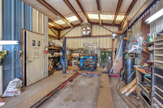 garage featuring a workshop area and wood walls