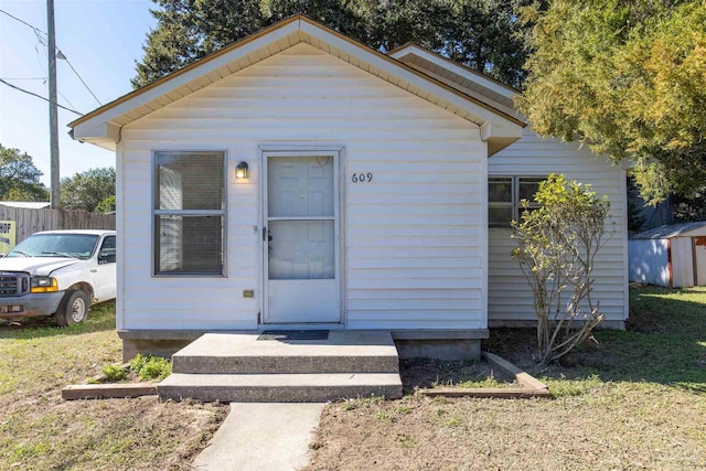 bungalow-style house with a storage shed