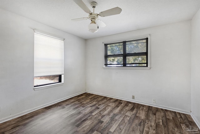 empty room featuring dark wood-type flooring and ceiling fan