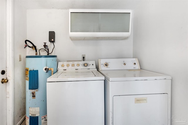 clothes washing area with washing machine and dryer and electric water heater