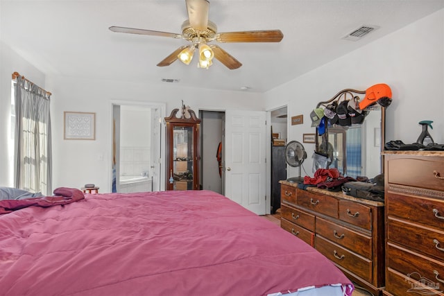 bedroom with ceiling fan and ensuite bath