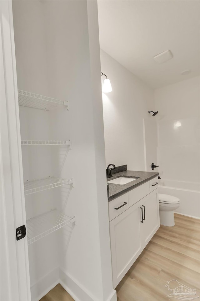 2120 W Desoto St, Pensacola, FL 32505 - bathroom with vanity, toilet, wood finished floors, and  shower combination