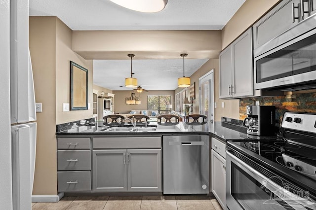 8425 Gulf Blvd Unit 206, Navarre Beach, FL 32566 - kitchen with decorative light fixtures, appliances with stainless steel finishes, gray cabinets, and a sink