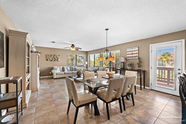 8425 Gulf Blvd Unit 206, Navarre Beach, FL 32566 - dining room featuring baseboards, a ceiling fan, light tile patterned flooring, and a textured ceiling