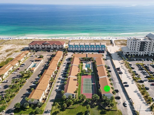 drone / aerial view featuring a water view and a beach view