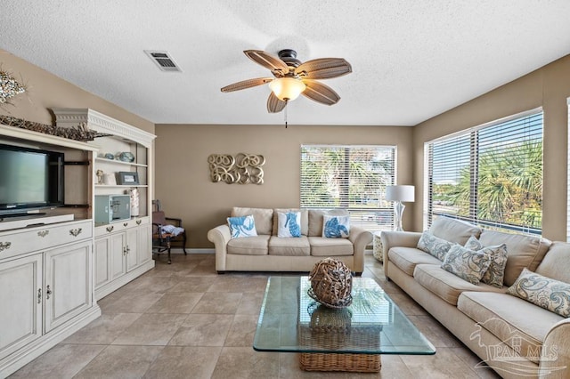 8425 Gulf Blvd Unit 206, Navarre Beach, FL 32566 - living room with a ceiling fan, baseboards, visible vents, and a textured ceiling