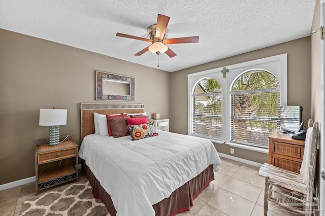 8425 Gulf Blvd Unit 206, Navarre Beach, FL 32566 - bedroom with a textured ceiling, baseboards, a ceiling fan, and light tile patterned floors
