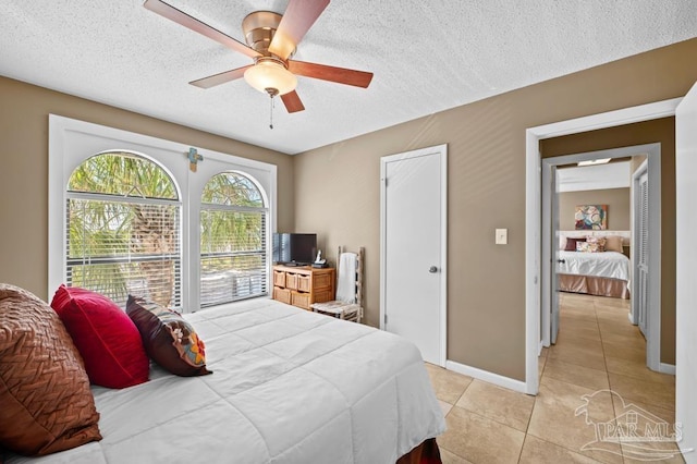 8425 Gulf Blvd Unit 206, Navarre Beach, FL 32566 - bedroom featuring ceiling fan, a textured ceiling, baseboards, and light tile patterned floors