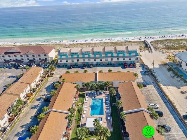 birds eye view of property with a view of the beach and a water view