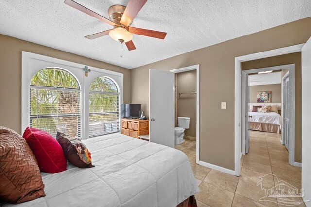8425 Gulf Blvd Unit 206, Navarre Beach, FL 32566 - bedroom with a textured ceiling, ensuite bathroom, baseboards, and light tile patterned floors