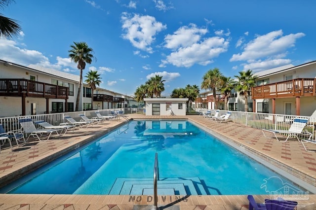 8425 Gulf Blvd Unit 206, Navarre Beach, FL 32566 - community pool with a patio area, fence, and a residential view