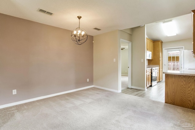 6027 Dallas Ave, Pensacola, FL 32526 - kitchen with white appliances, light colored carpet, a chandelier, light countertops, and hanging light fixtures