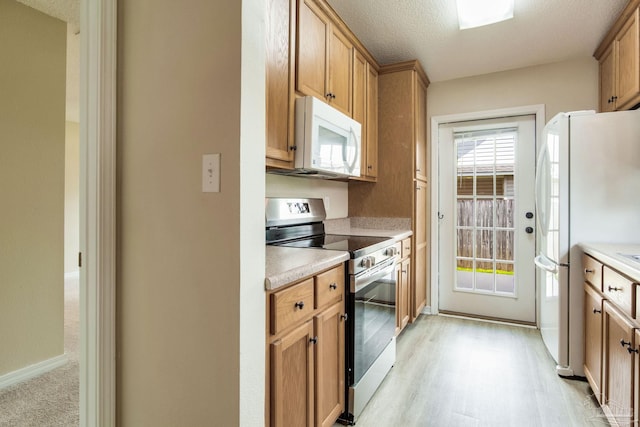 6027 Dallas Ave, Pensacola, FL 32526 - kitchen with white appliances, light countertops, and light wood-type flooring