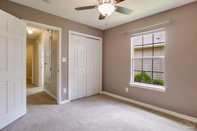 6027 Dallas Ave, Pensacola, FL 32526 - unfurnished bedroom with carpet flooring, multiple windows, a closet, and ceiling fan