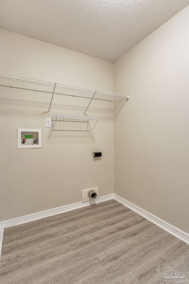 6027 Dallas Ave, Pensacola, FL 32526 - washroom featuring hookup for an electric dryer, light wood-style flooring, washer hookup, and a textured ceiling