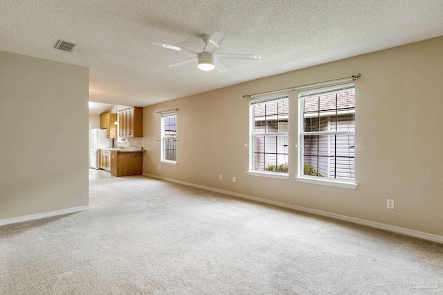 6027 Dallas Ave, Pensacola, FL 32526 - unfurnished living room featuring light colored carpet, ceiling fan, and a textured ceiling