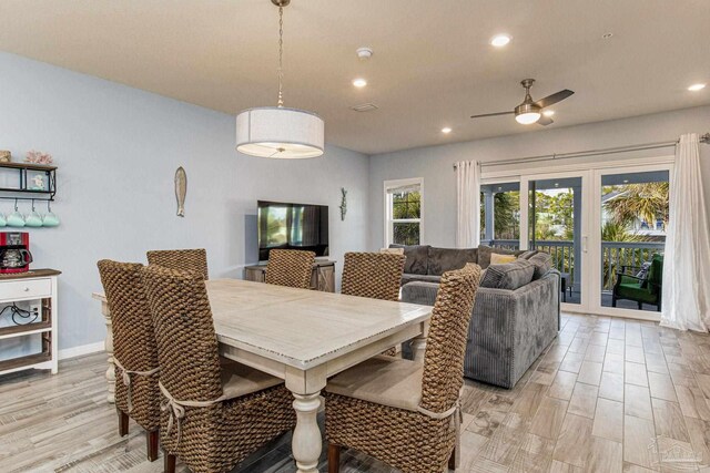 dining room with ceiling fan and light wood-type flooring