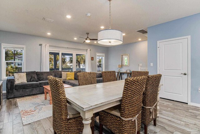 dining area featuring ceiling fan and light hardwood / wood-style flooring