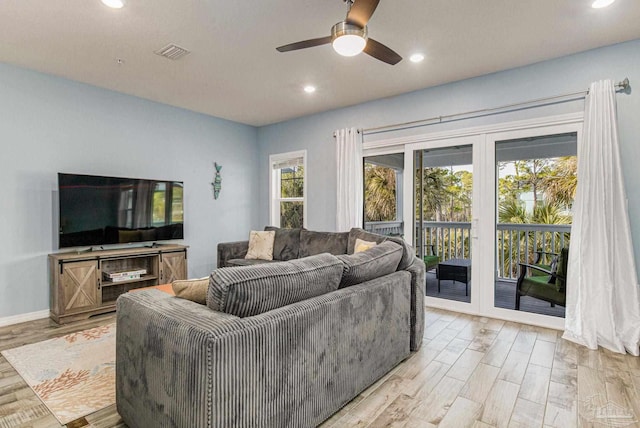 living room featuring light wood-type flooring and ceiling fan