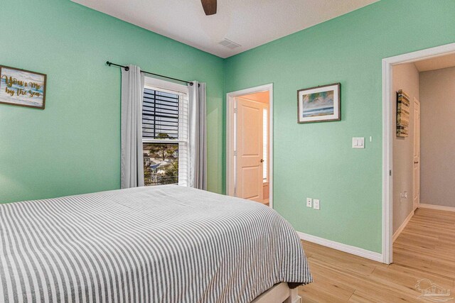 bedroom with ceiling fan and hardwood / wood-style floors