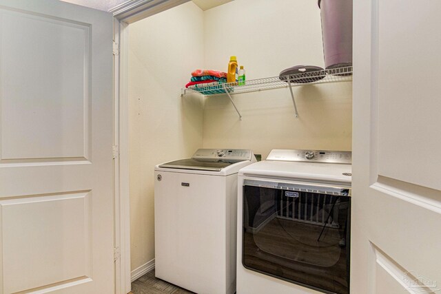 clothes washing area with washing machine and clothes dryer