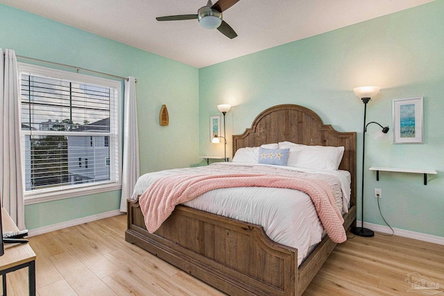 bedroom with light hardwood / wood-style floors and ceiling fan