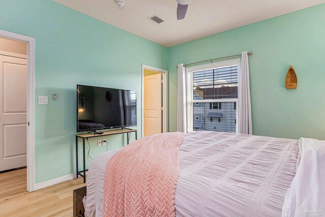 bedroom with light hardwood / wood-style flooring and ceiling fan