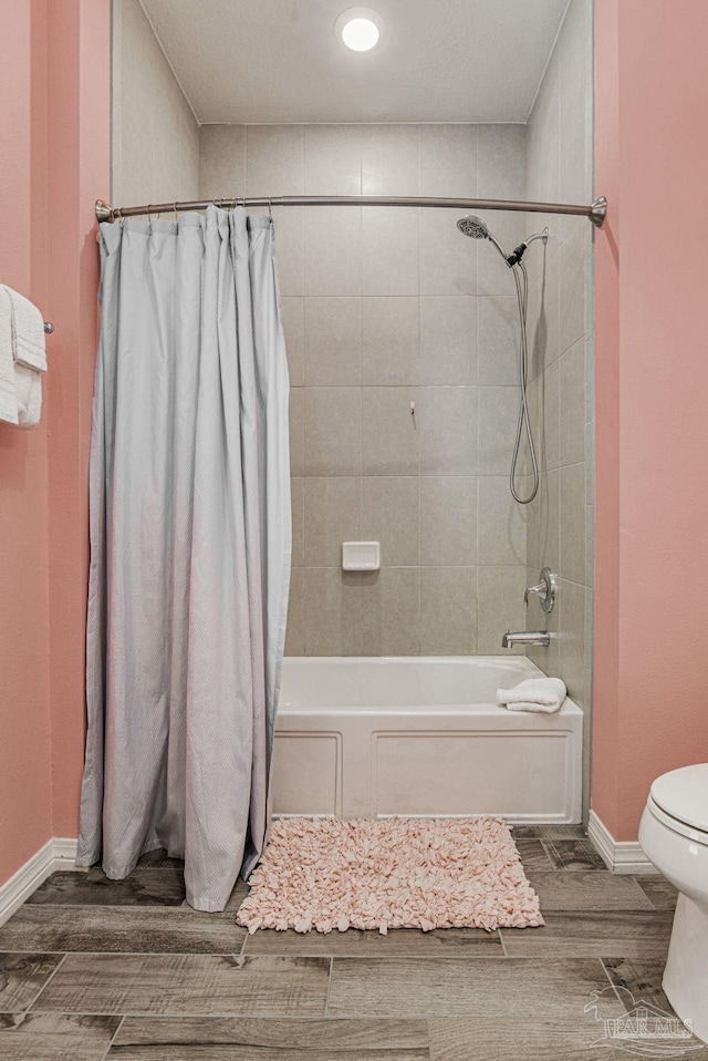 bathroom with shower / bath combo with shower curtain and toilet